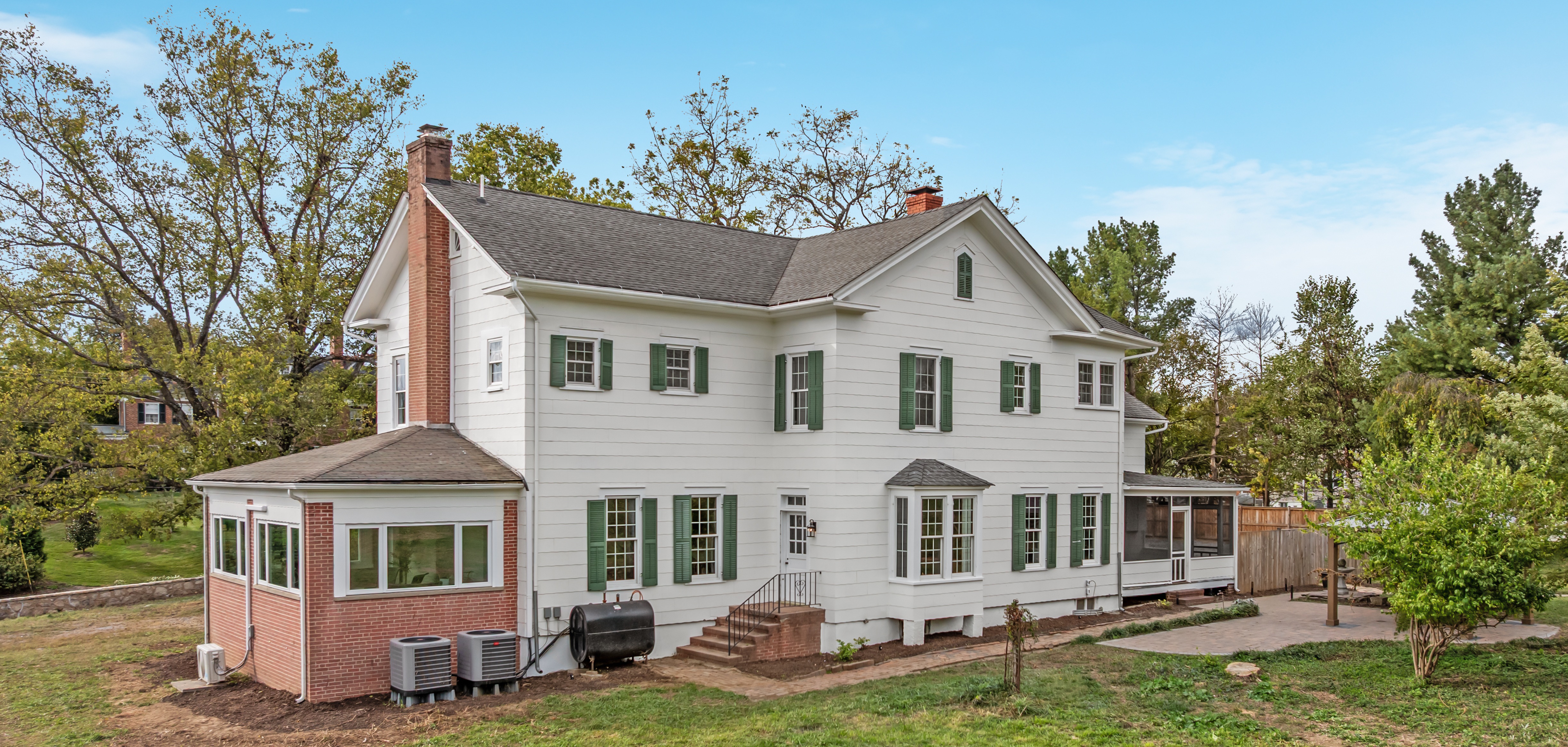 Cash home buyer inspecting a house exterior in the Shenandoah Valley, Virginia